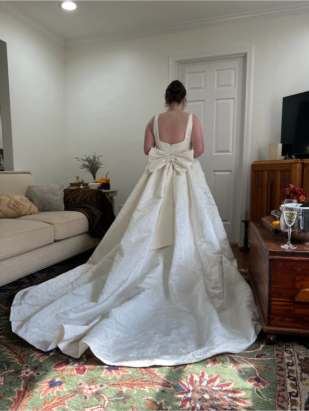 Azazie “Skylin” floral jacquard ballgown in color antique white with back bow